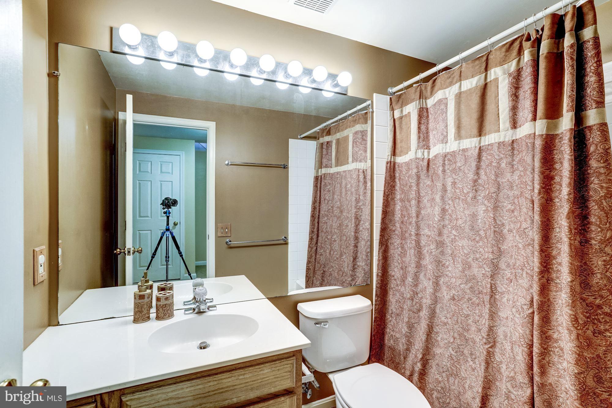 43315 Parlor Square Ashburn, VA 20147 - Photo 18 of 31 a bathroom with a sink a toilet and mirror