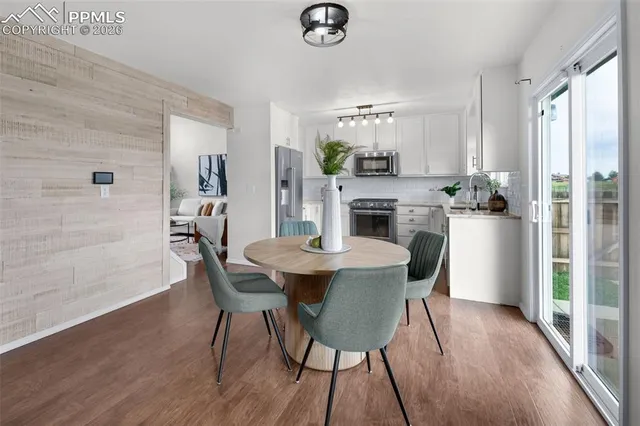 a view of a dining room with furniture window and wooden floor