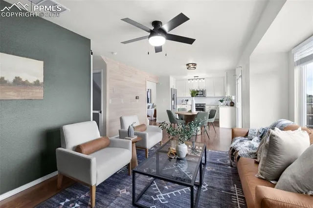 a living room with furniture and view of kitchen