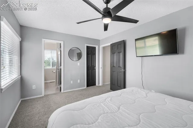 a bedroom with a large bed and a flat screen tv