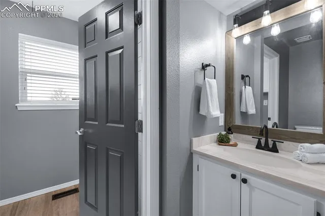 a bathroom with a double vanity sink and a mirror