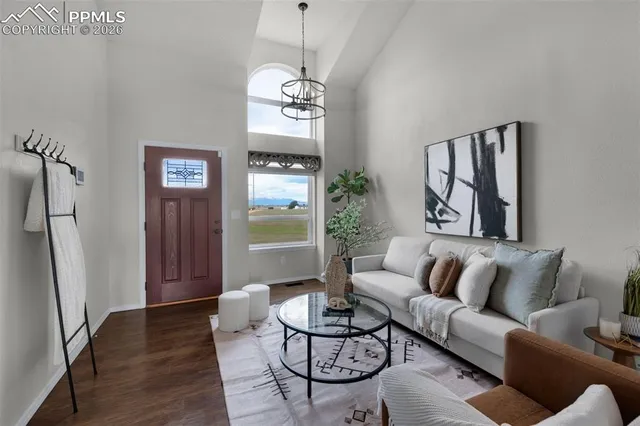 a living room with furniture a dining table and a window