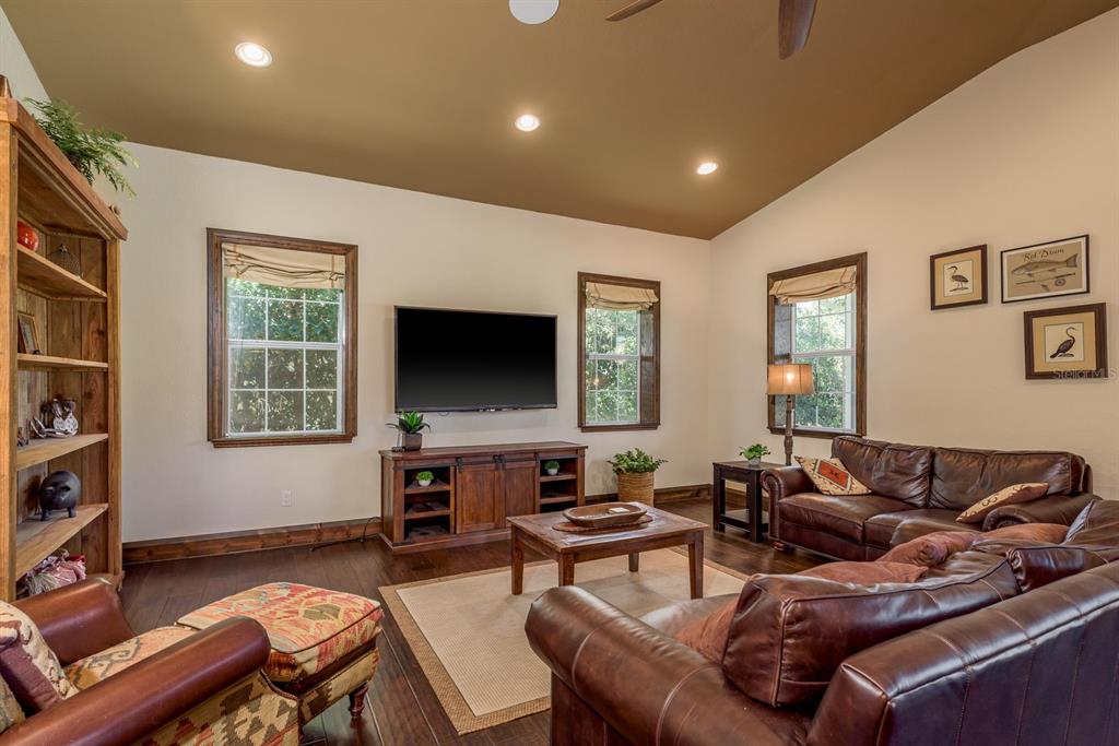 19018 Blake Road Odessa, FL 33556 - Photo 11 of 40 a living room with furniture and a flat screen tv