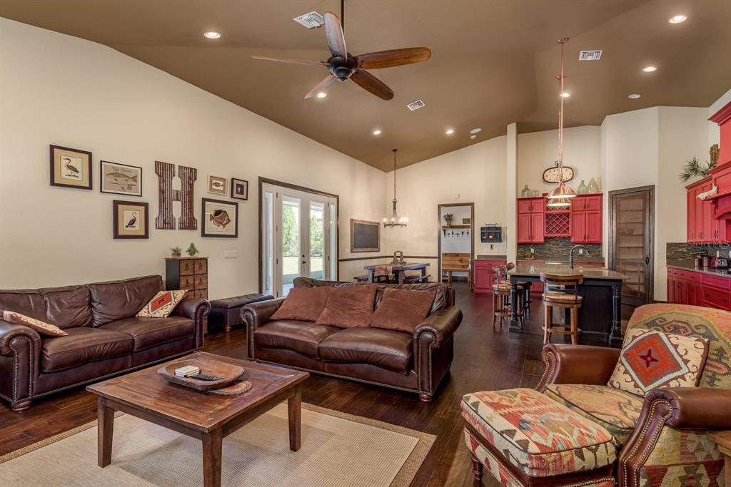 19018 Blake Road Odessa, FL 33556 - Photo 12 of 40 a living room with furniture kitchen view and a chandelier