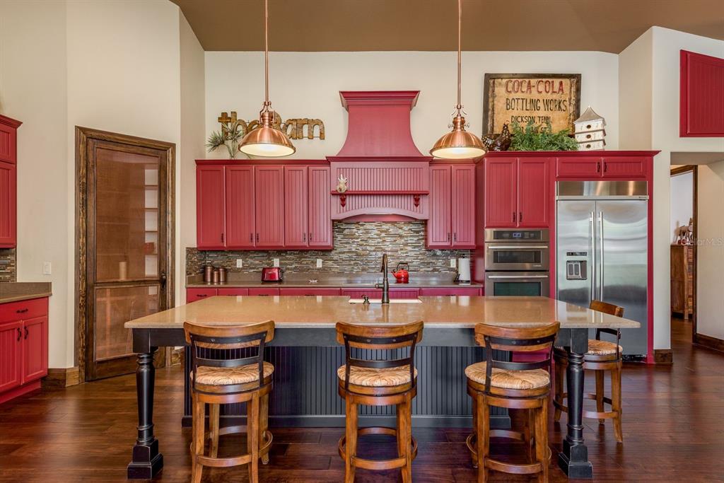 19018 Blake Road Odessa, FL 33556 - Photo 14 of 40 a kitchen with a sink and chairs
