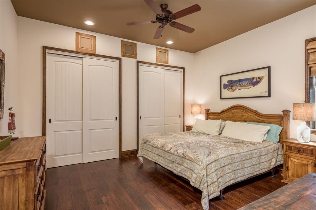 19018 Blake Road Odessa, FL 33556 - Photo 20 of 40 a bedroom with a large bed and a chandelier