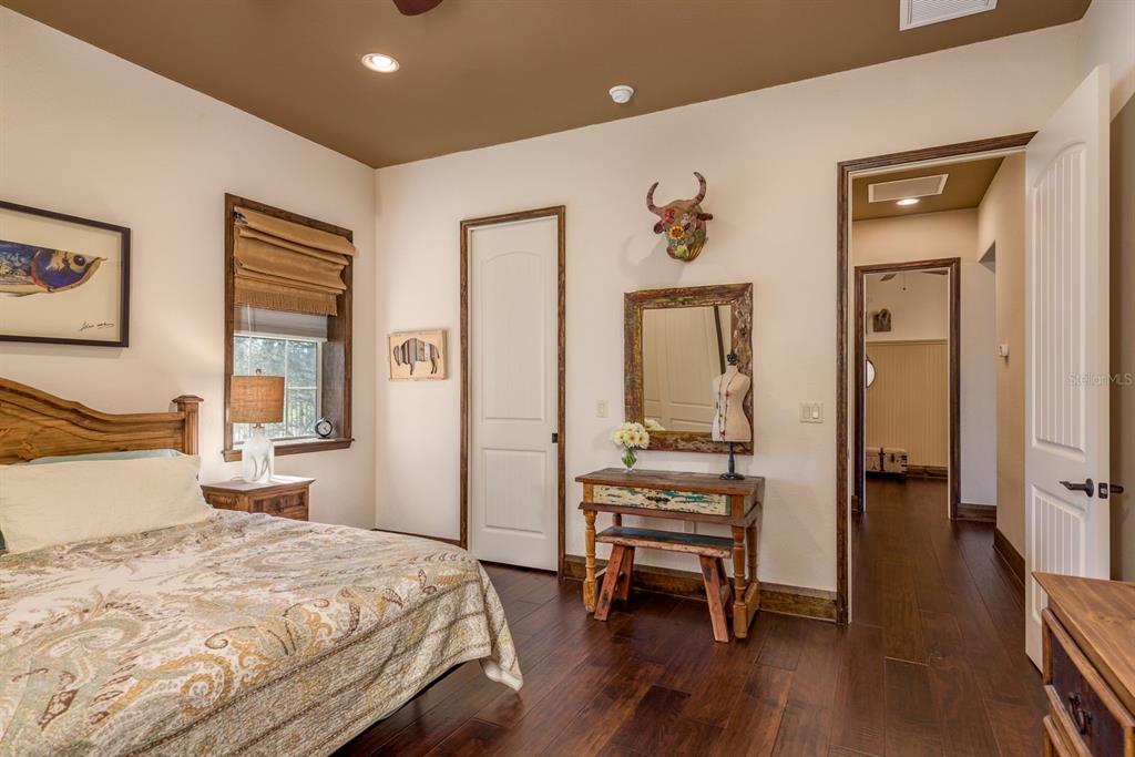 19018 Blake Road Odessa, FL 33556 - Photo 21 of 40 a bedroom with a bed and wooden floor