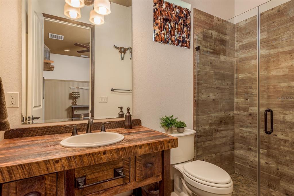 19018 Blake Road Odessa, FL 33556 - Photo 25 of 40 a bathroom with a sink a toilet and shower