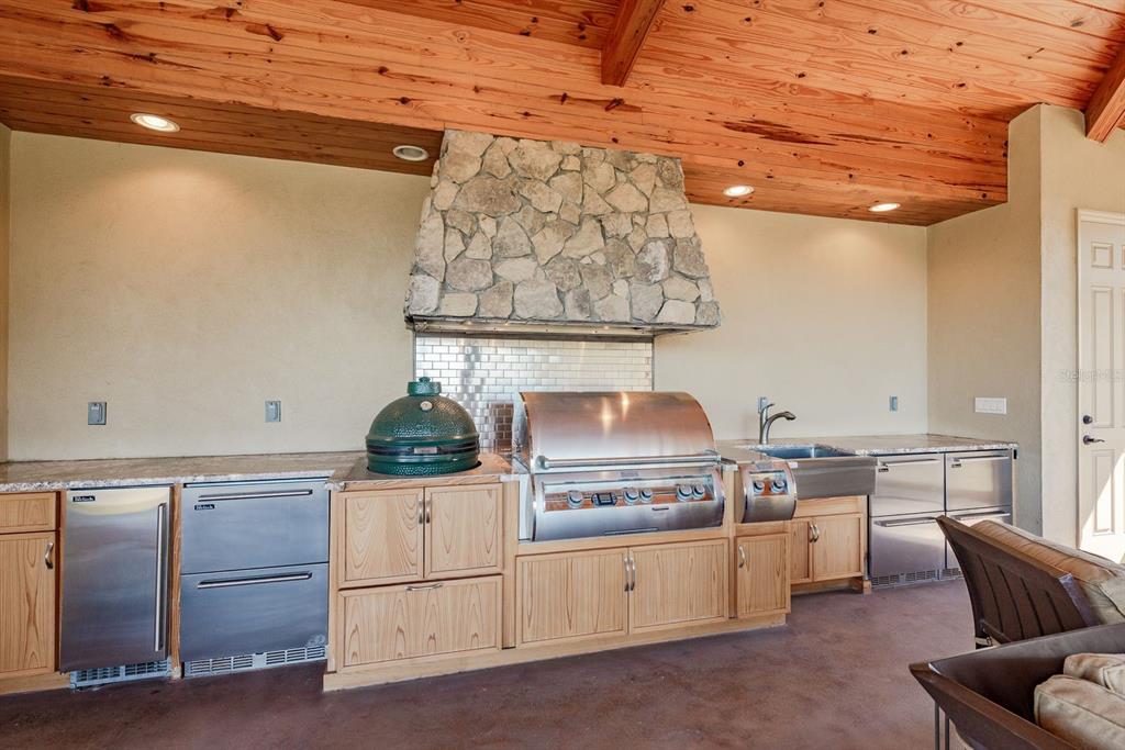 19018 Blake Road Odessa, FL 33556 - Photo 30 of 40 a kitchen with furniture a stove and white cabinets