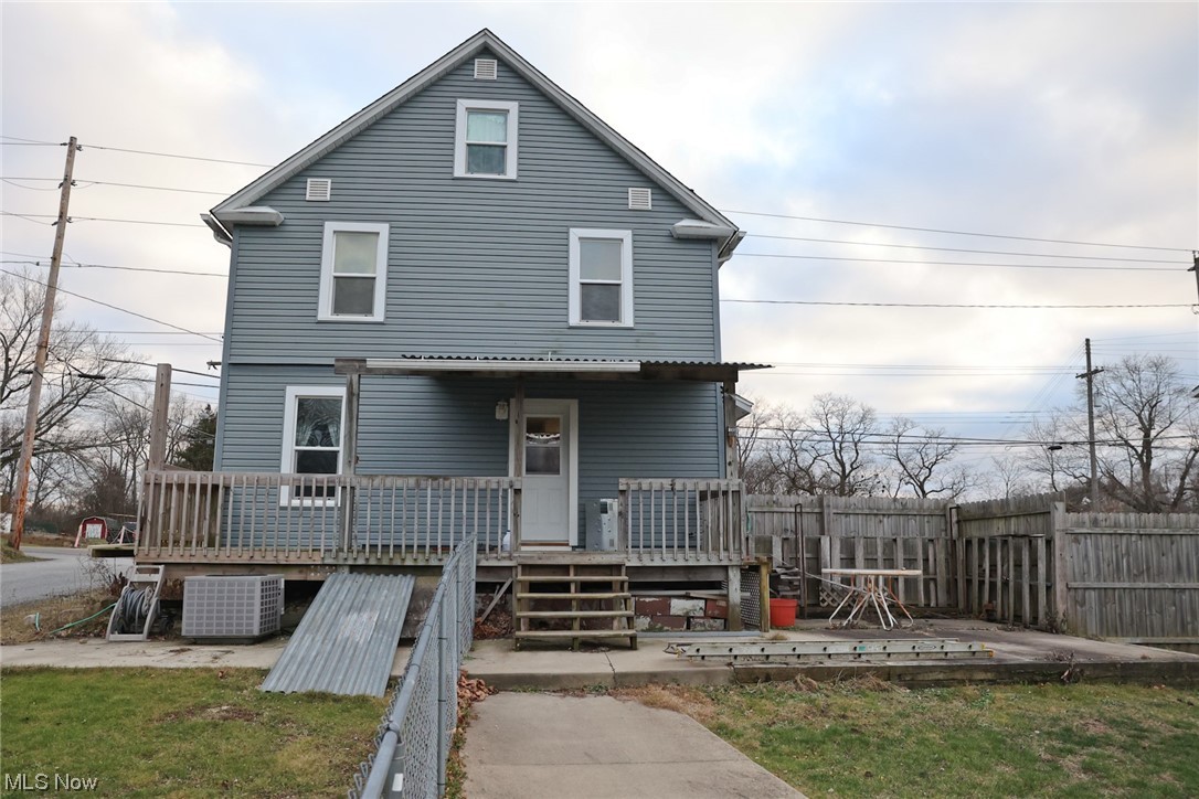 1309 Krumroy Road Akron, OH 44306 - Photo 3 of 30 View of front of house featuring central AC and a wooden deck