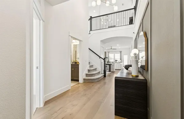 a view of entryway and hall with wooden floor