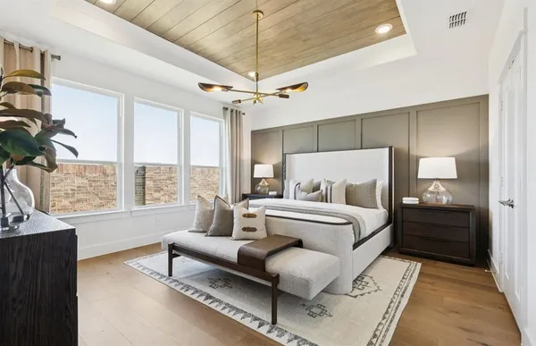 a spacious bedroom with a bed and a couch