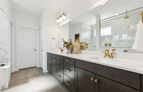 a bathroom with a sink double vanity mirror and a shower