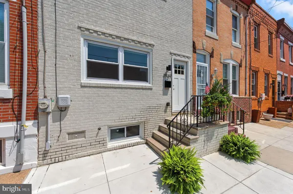 a building with potted plants in front of it