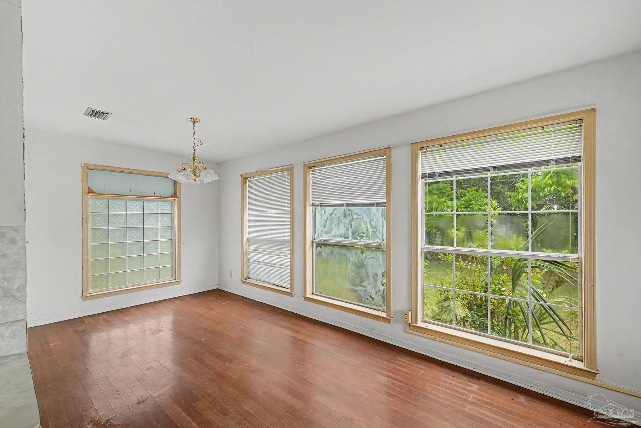 333 Gibbs Road Pensacola, FL 32507 - Photo 10 of 34 a view of an empty room with wooden floor and a window