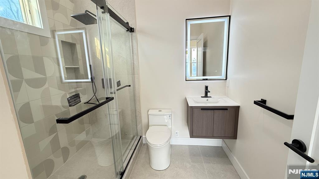 24 Peterson Road Wayne, NJ 07470 - Photo 15 of 31 a bathroom with a toilet sink and mirror