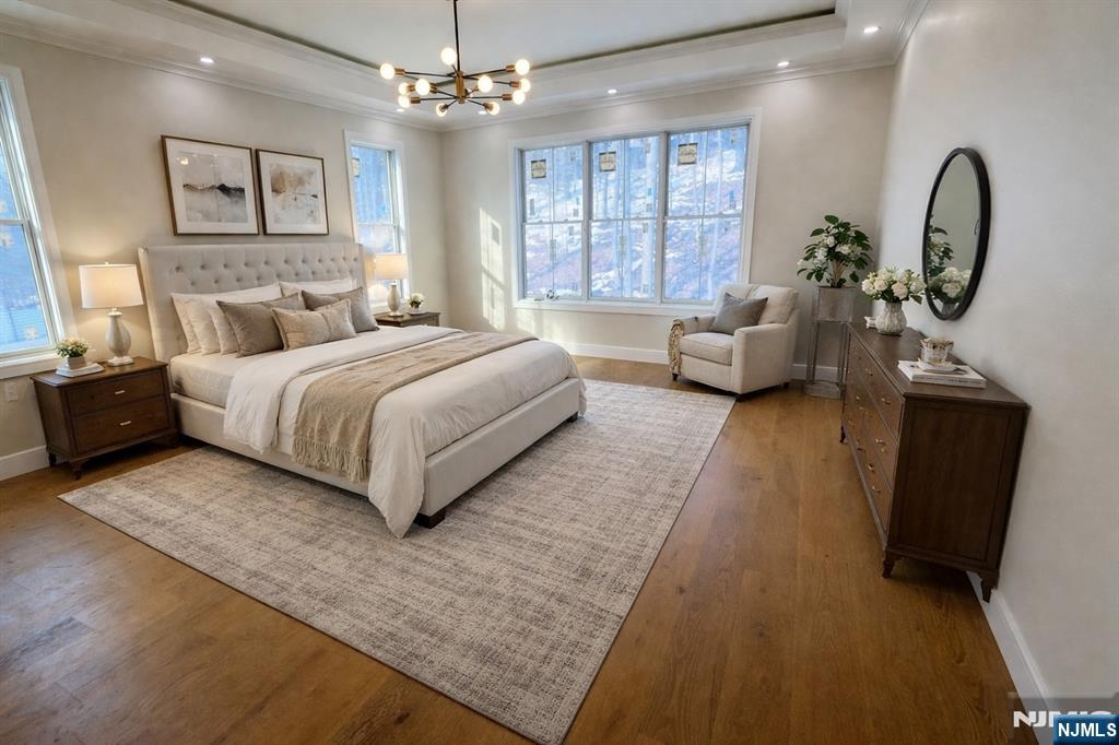 24 Peterson Road Wayne, NJ 07470 - Photo 20 of 31 a spacious bedroom with a bed a couch and dresser with wooden floor