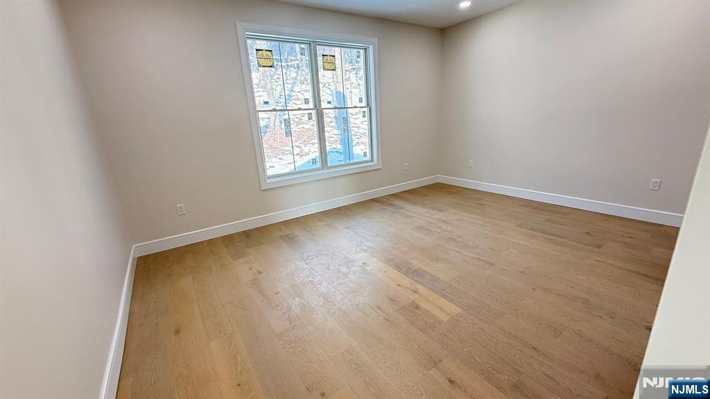24 Peterson Road Wayne, NJ 07470 - Photo 28 of 31 an empty room with wooden floor and windows