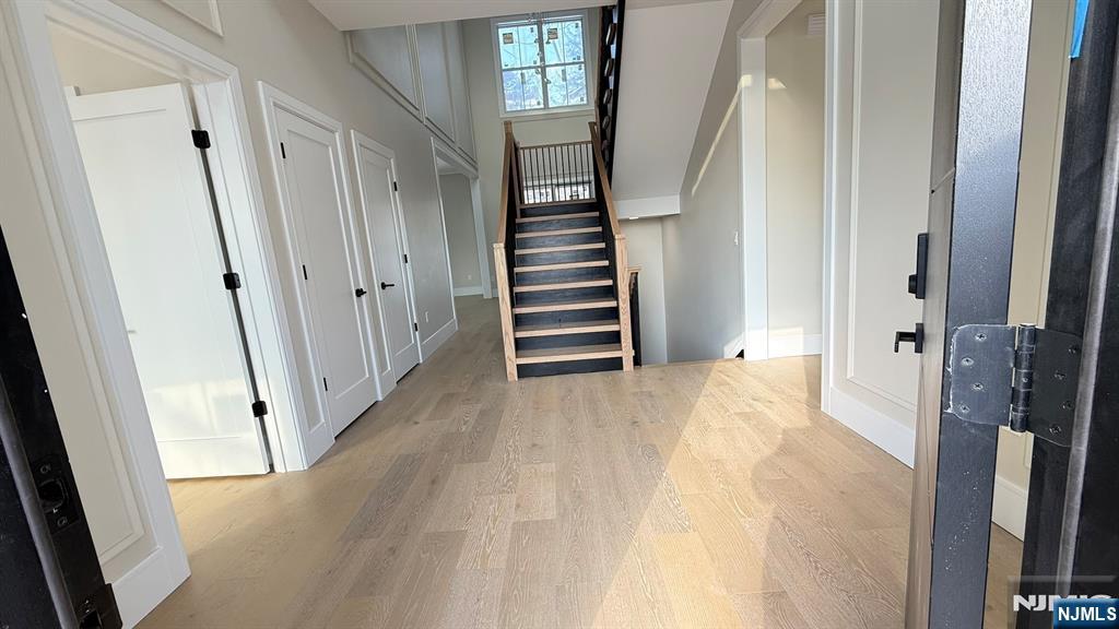 24 Peterson Road Wayne, NJ 07470 - Photo 3 of 31 a view of a hallway with wooden floor and staircase