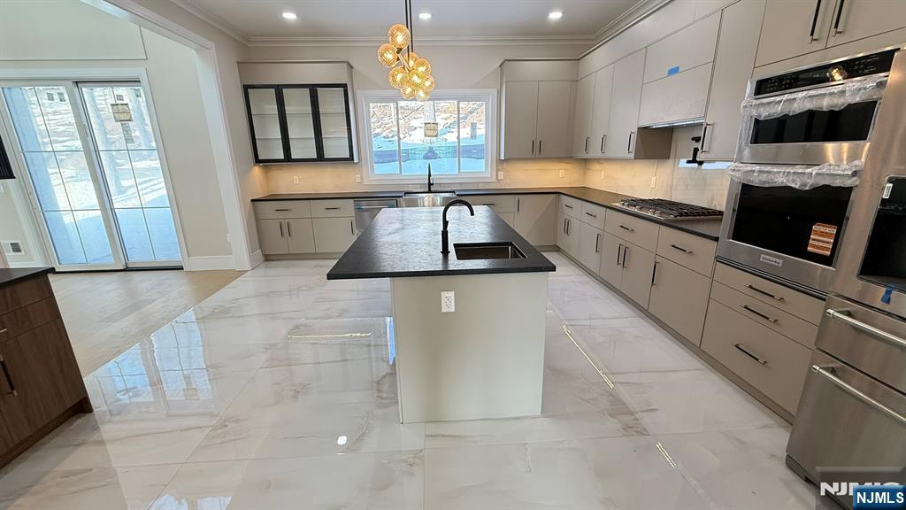 24 Peterson Road Wayne, NJ 07470 - Photo 8 of 31 a large kitchen with granite countertop a stove a sink and a microwave