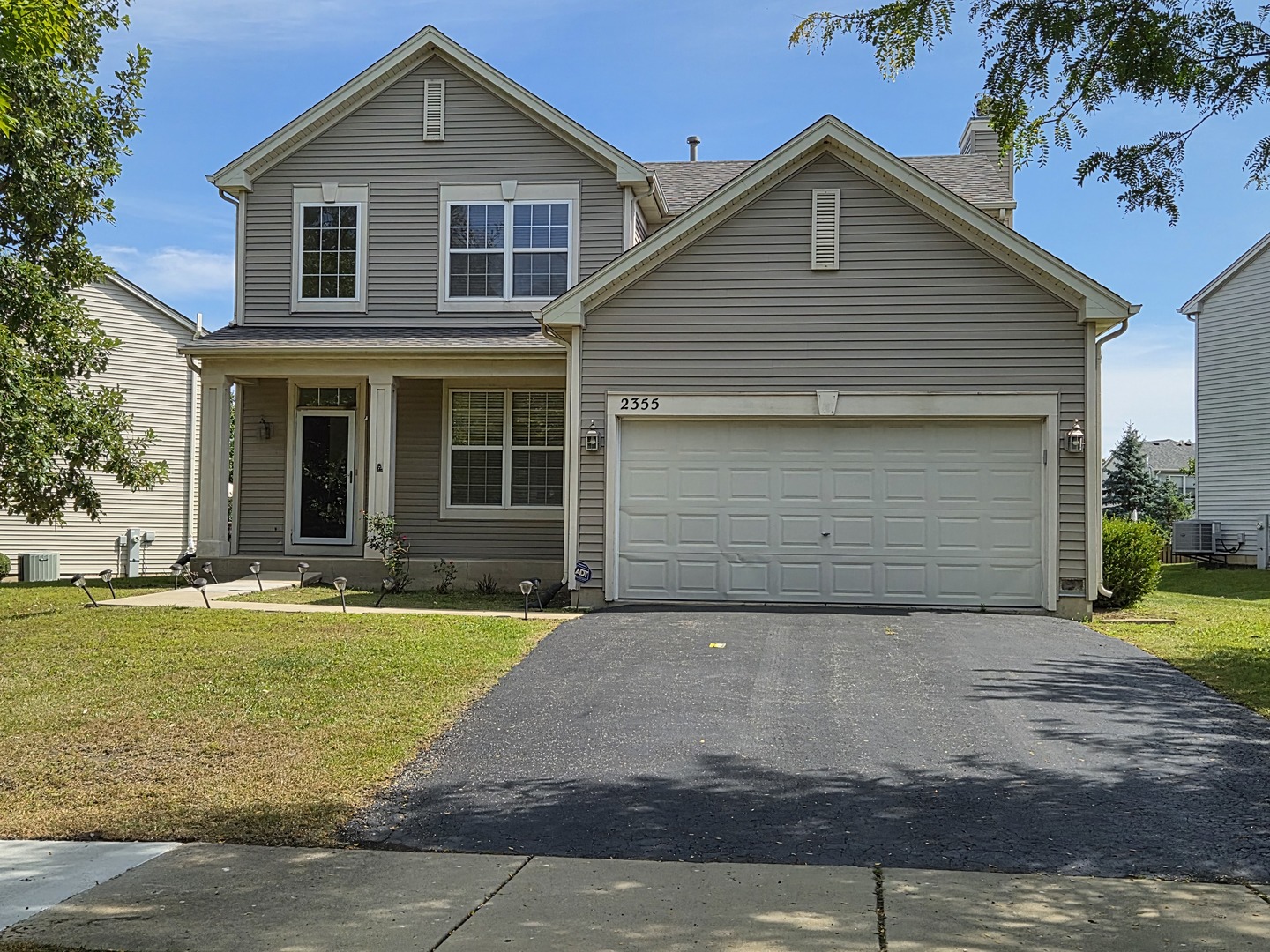 2355 Shiloh Drive Aurora, IL 60503 - Photo 1 of 40 a front view of a house with a yard and garage