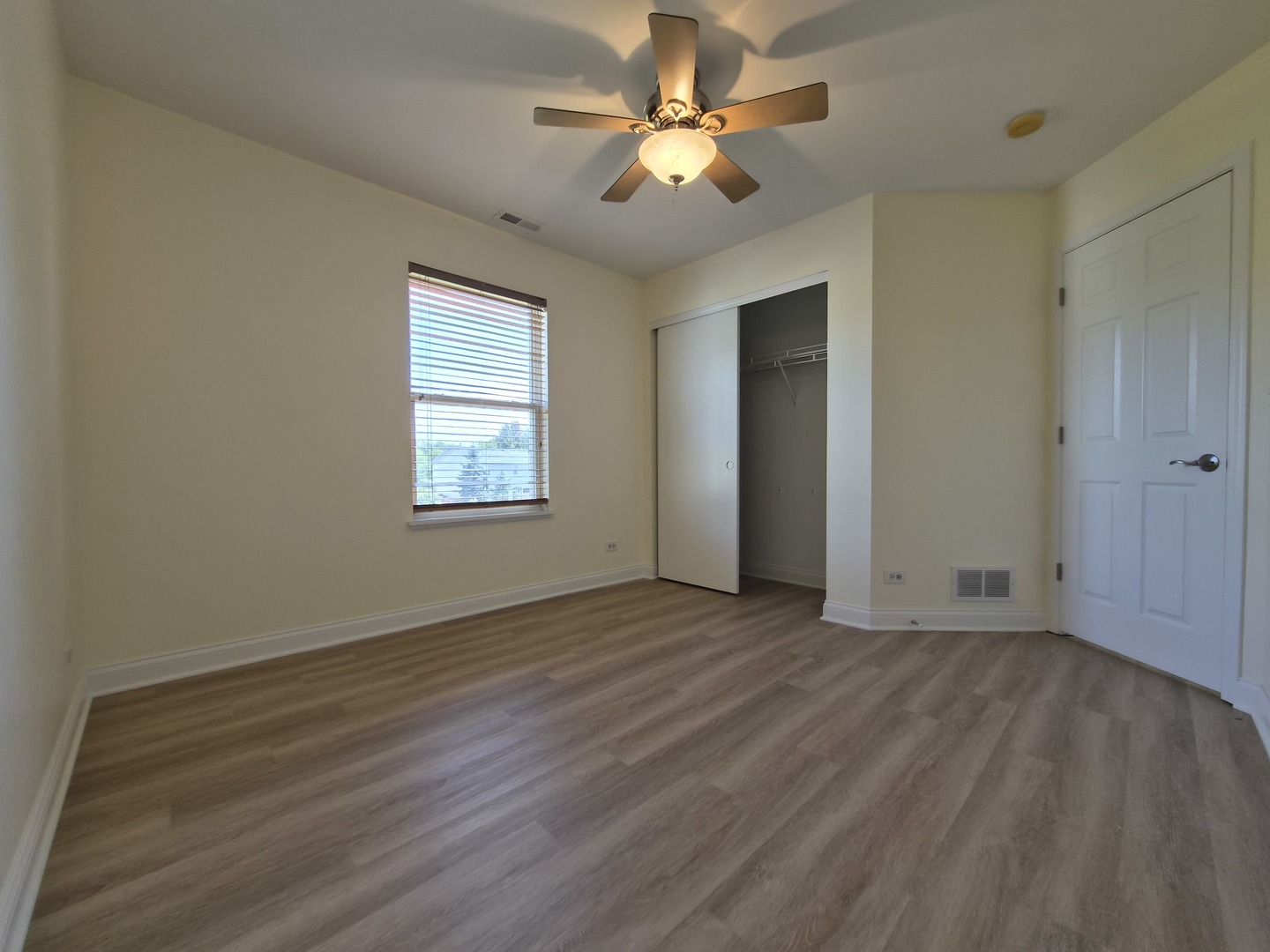 2355 Shiloh Drive Aurora, IL 60503 - Photo 22 of 40 a view of an empty room with a window and wooden floor