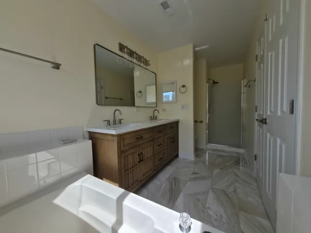 a bathroom with a sink double vanity and a mirror