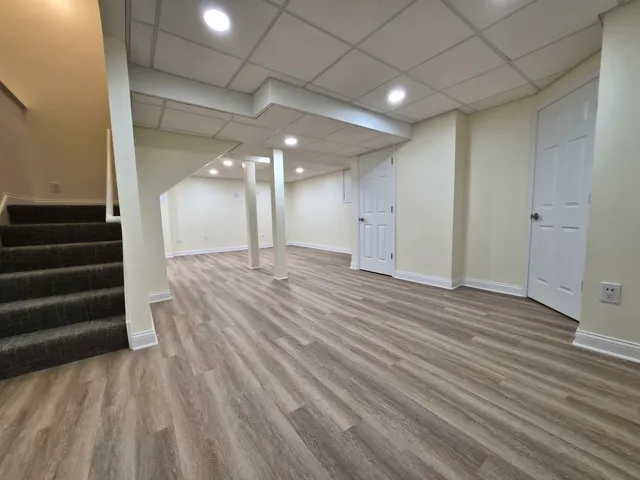 a view of a room with stairs and a wooden floor