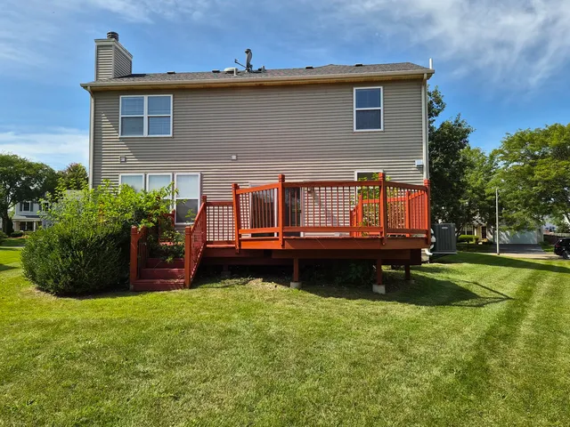 a view of a house with a small yard and sitting area
