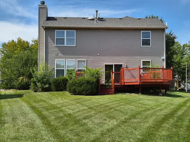 a view of a house with a yard and sitting area