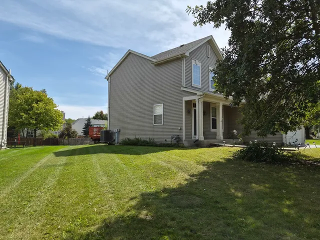 a front view of a house with a garden and yard
