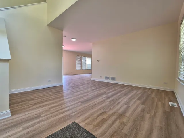 a view of an empty room and wooden floor
