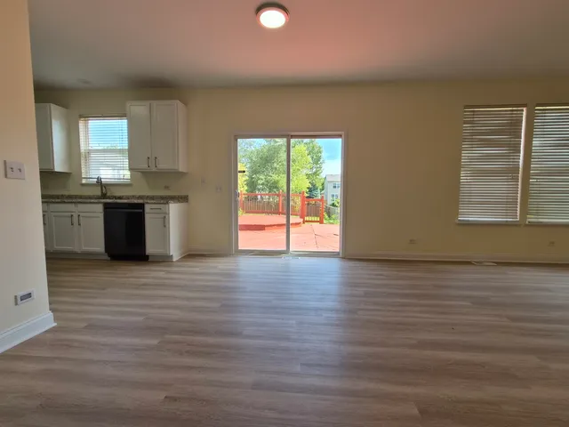 a view of a kitchen with a sink and a large window