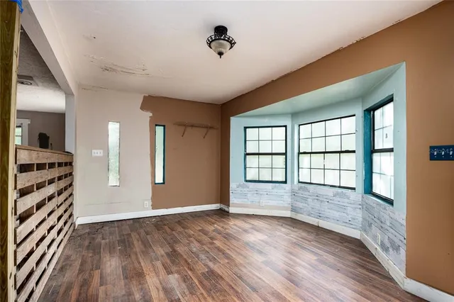 wooden floor in an empty room with a window