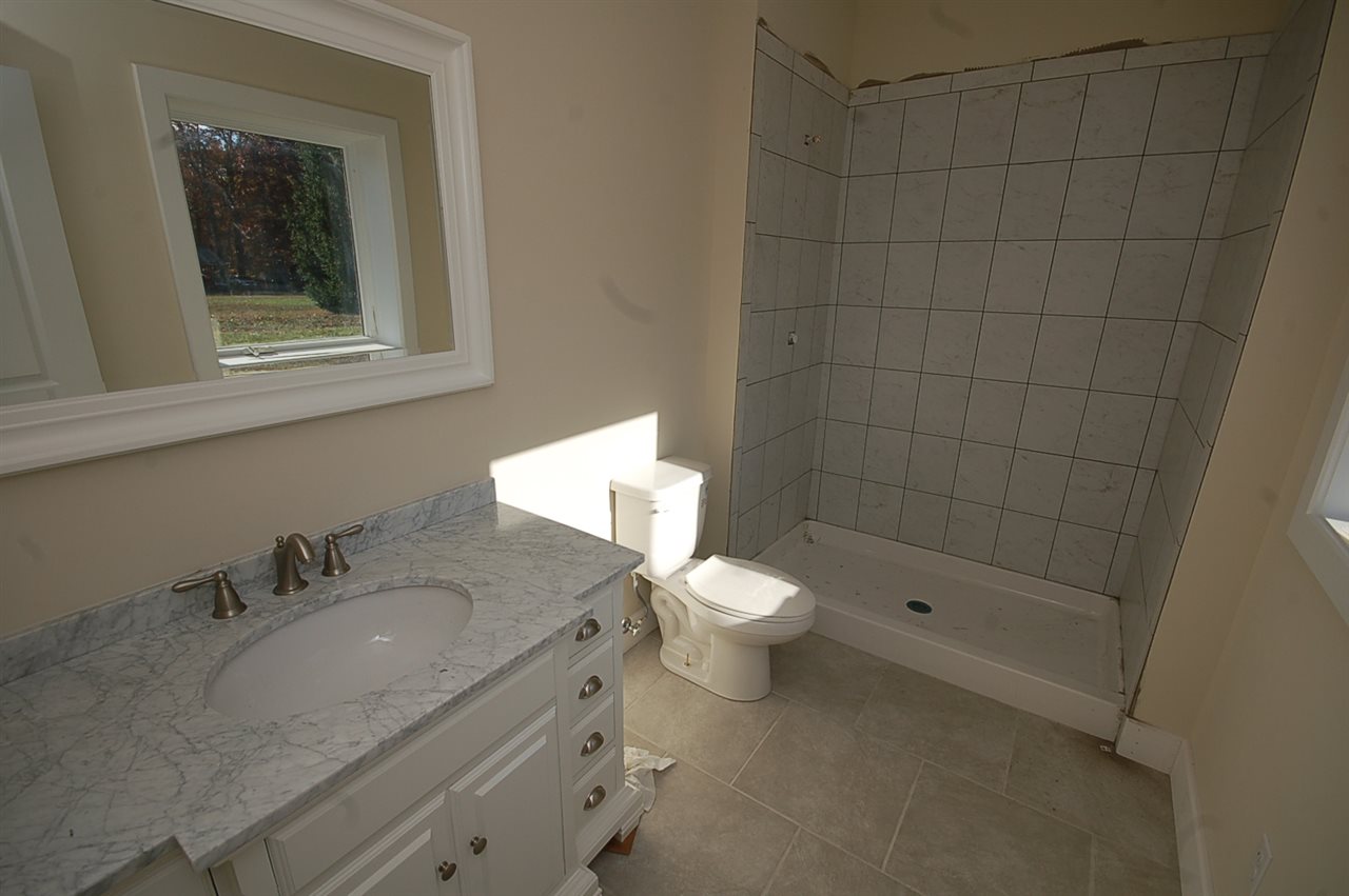2505 Dunnes Shop Road Ruckersville, VA 22968 - Photo 27 of 29 a bathroom with a granite countertop sink toilet and shower