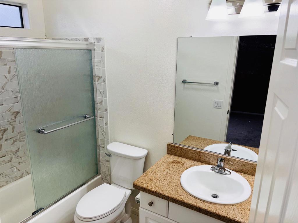 3545 Paseo De Francisco, Unit 225 Oceanside, CA 92056 - Photo 22 of 34 a bathroom with a sink a toilet and shower