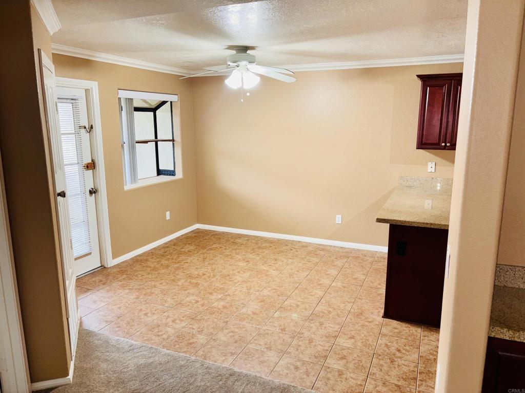 3545 Paseo De Francisco, Unit 225 Oceanside, CA 92056 - Photo 25 of 34 a view of an empty room with chandelier fan and a bathroom
