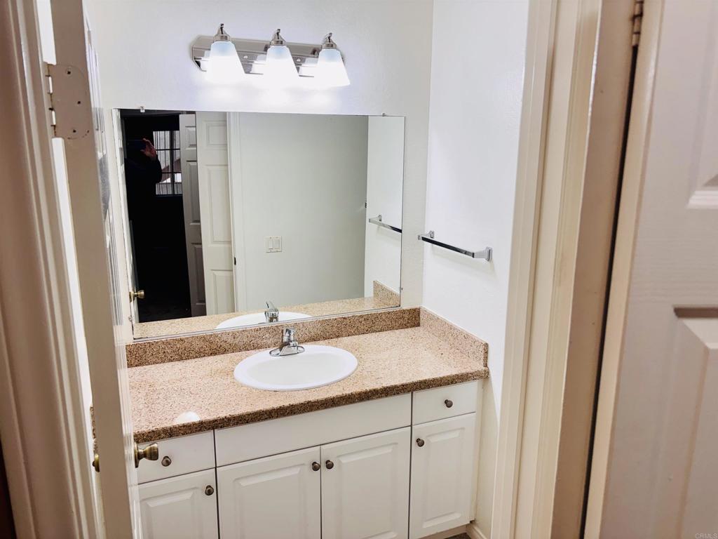 3545 Paseo De Francisco, Unit 225 Oceanside, CA 92056 - Photo 33 of 34 a bathroom with a sink and a mirror