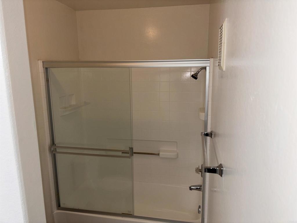 3545 Paseo De Francisco, Unit 225 Oceanside, CA 92056 - Photo 34 of 34 a bathroom with a glass shower door