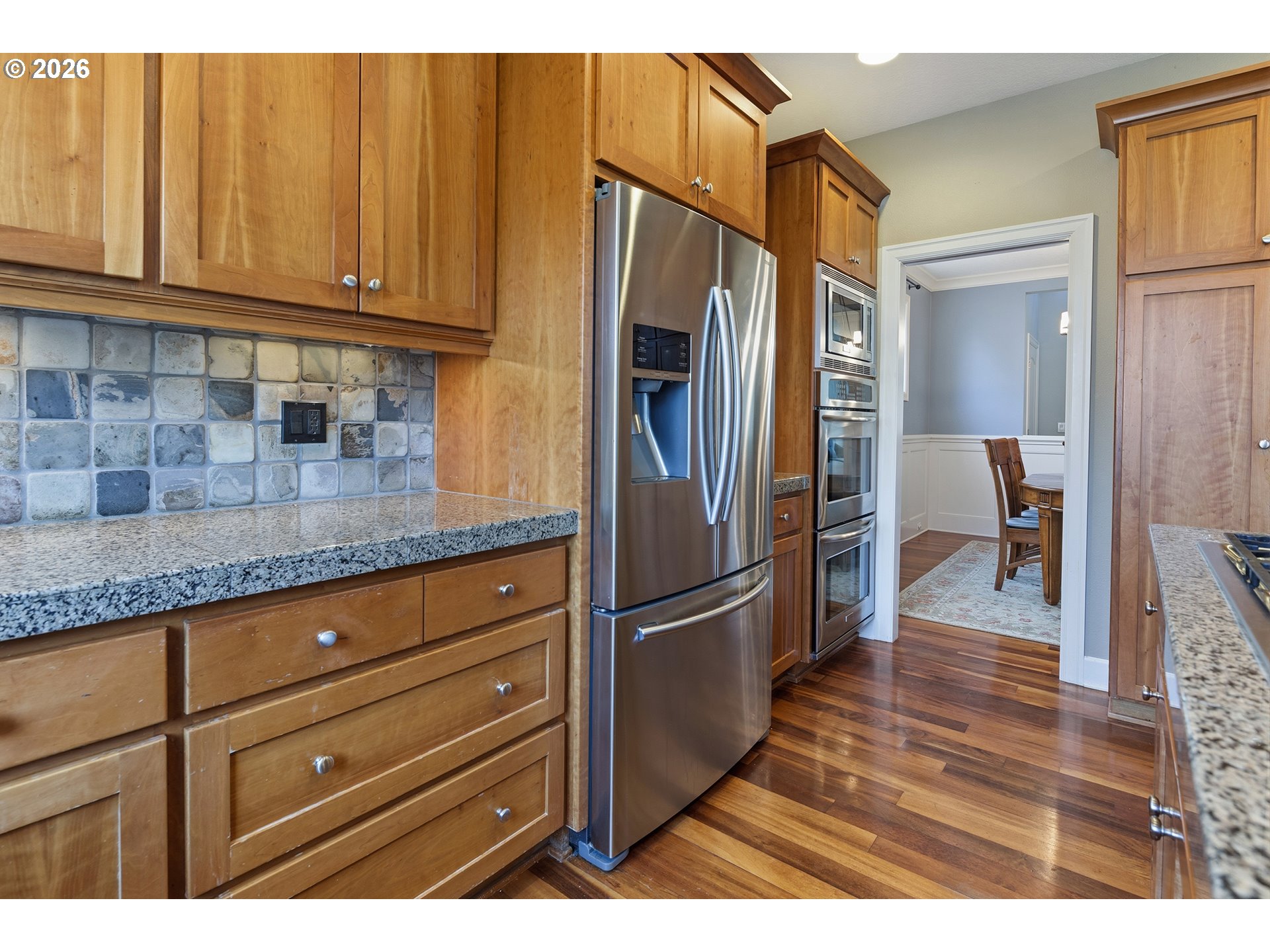 3525 Northwest Sunset View Terrace Portland, OR 97229 - Photo 15 of 48 a kitchen with granite countertop wooden cabinets and stainless steel appliances