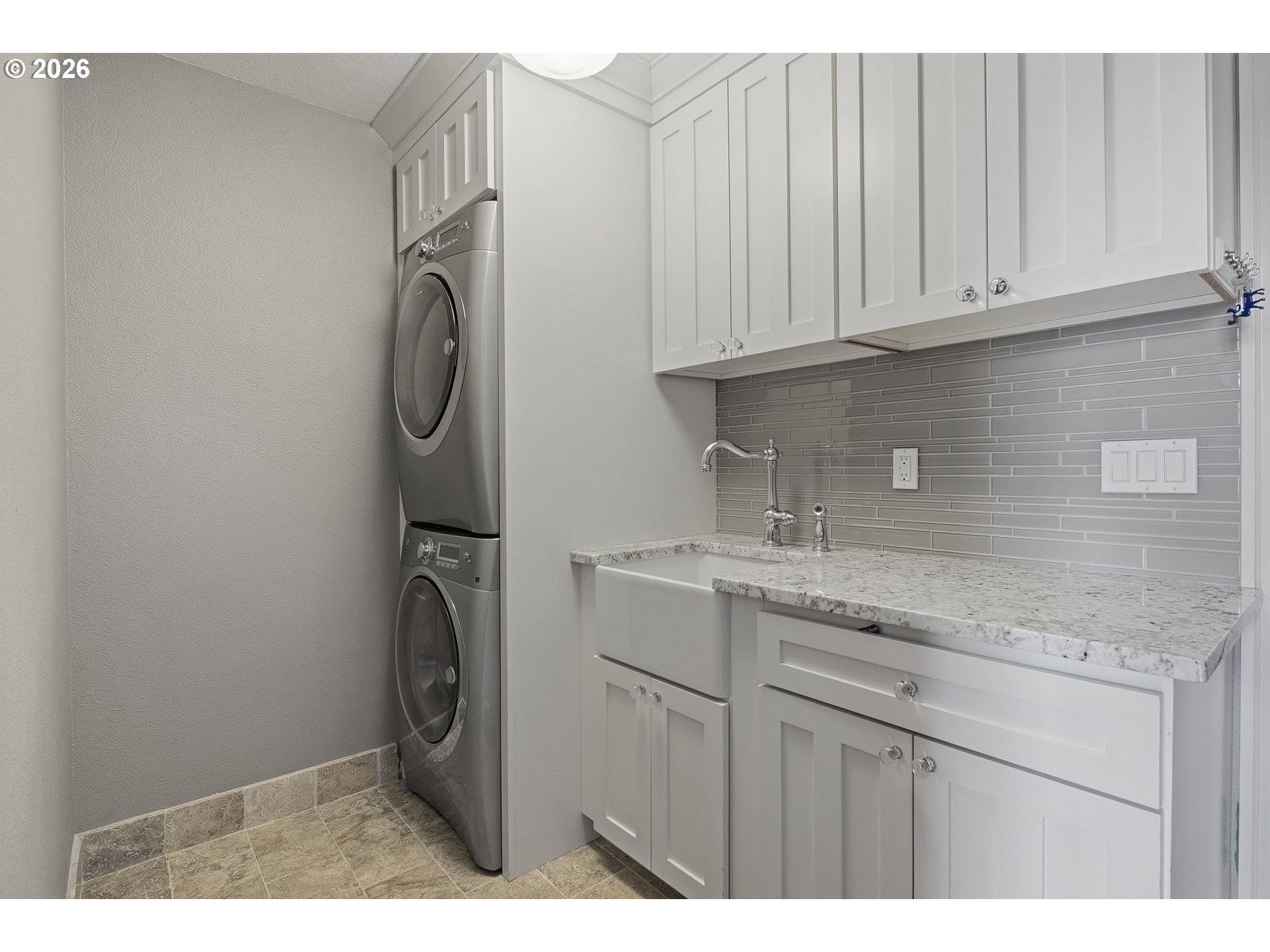 3525 Northwest Sunset View Terrace Portland, OR 97229 - Photo 17 of 48 a kitchen with stainless steel appliances granite countertop a sink a washer and dryer