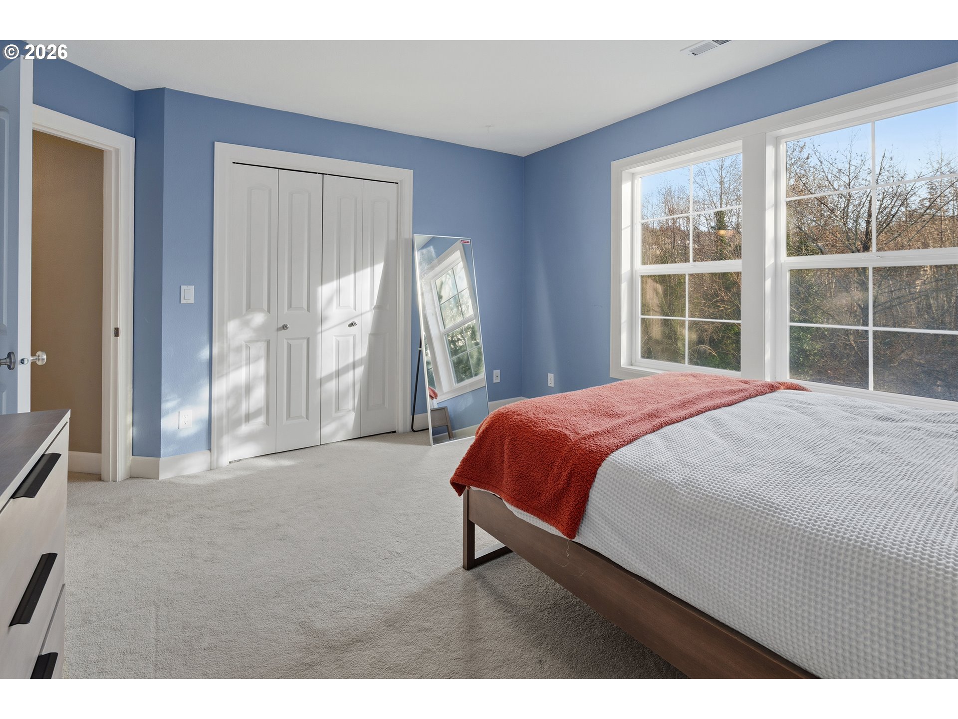 3525 Northwest Sunset View Terrace Portland, OR 97229 - Photo 28 of 48 a bedroom with a bed and a large window