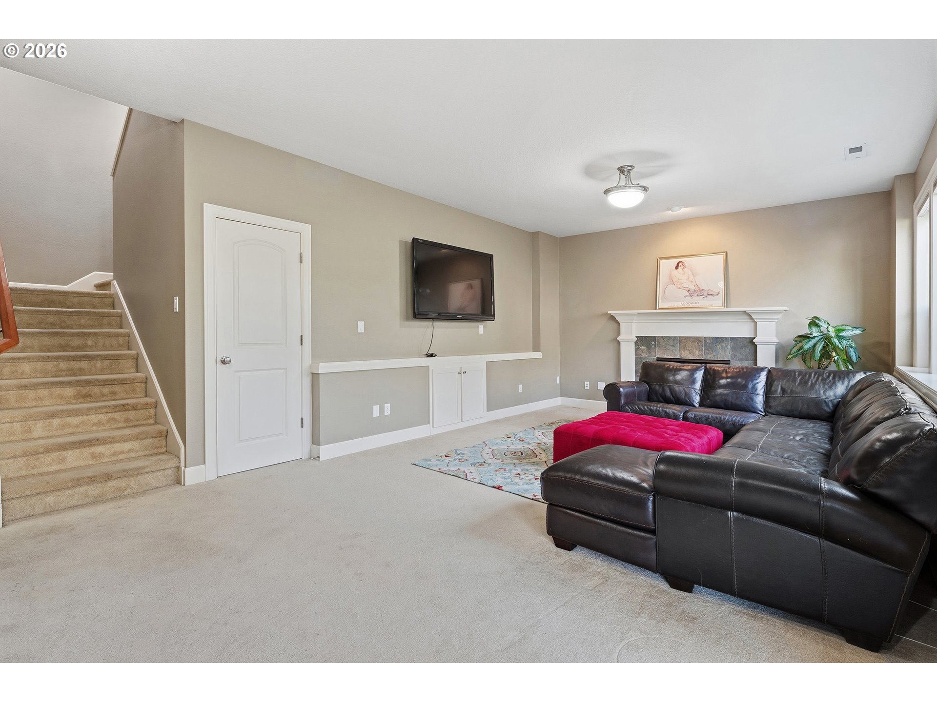 3525 Northwest Sunset View Terrace Portland, OR 97229 - Photo 33 of 48 a living room with furniture a flat screen tv and a fireplace