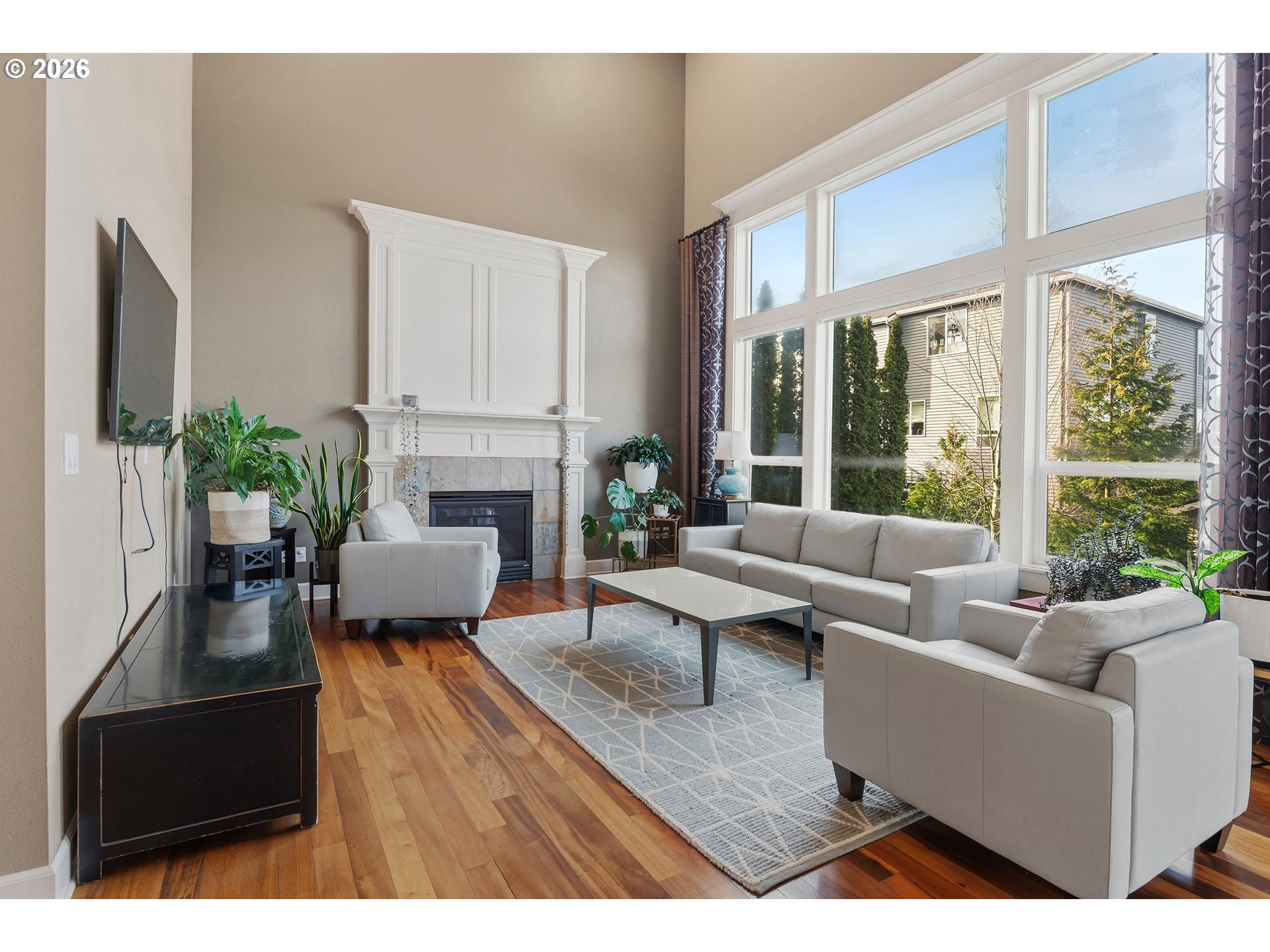 3525 Northwest Sunset View Terrace Portland, OR 97229 - Photo 5 of 48 a living room with furniture a large window and a fireplace