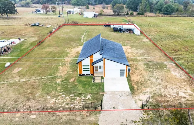 a view of swimming pool with lawn chairs and large trees