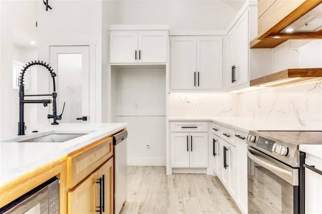 a kitchen with sink cabinets and a stove