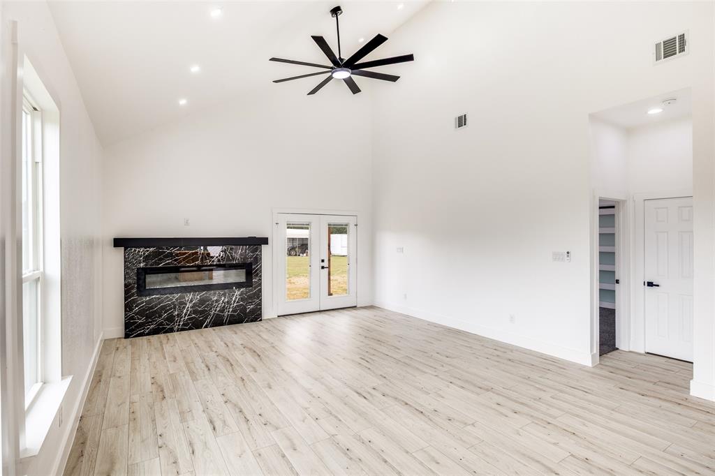 2125 Rs County Road 3150 Emory, TX 75440 - Photo 17 of 40 a view of an empty room with a window and a kitchen