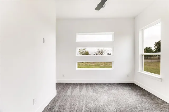 a kitchen with stainless steel appliances granite countertop a stove a sink and white cabinets