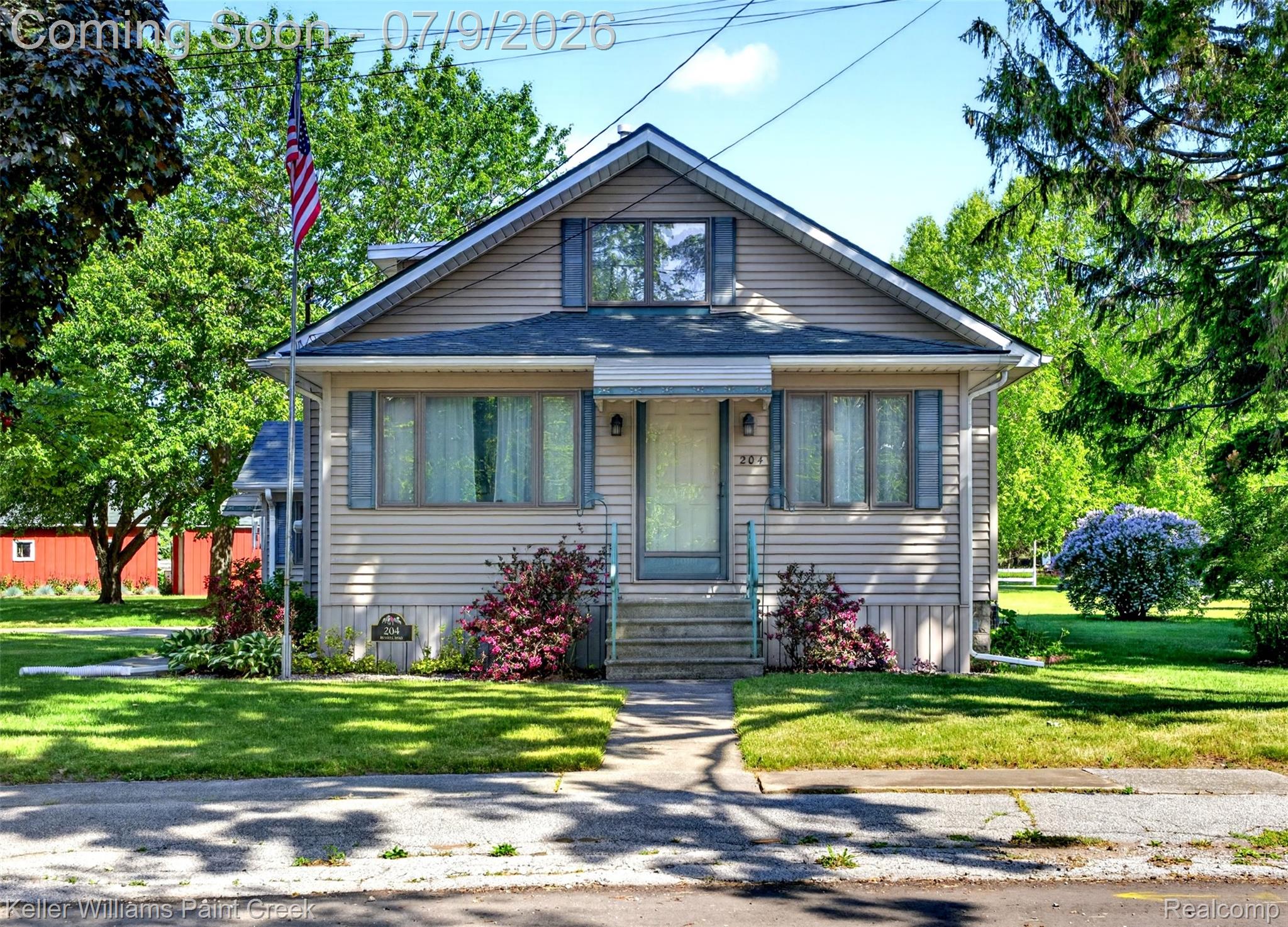 204 Russell Road Kawkawlin, MI 48631 - Photo 69 of 82 Gable-front home featuring beige siding and blue window shutters