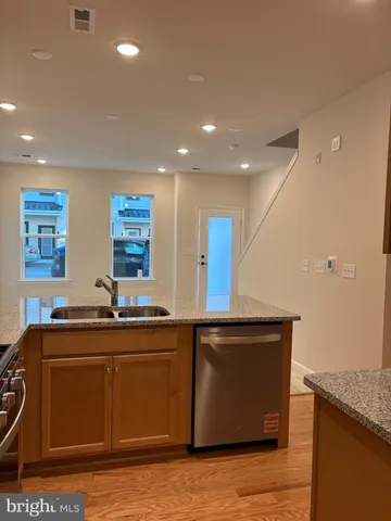 a kitchen with stainless steel appliances granite countertop a sink stove and microwave